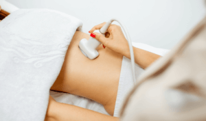 early pregnancy scan performed on lady's stomack